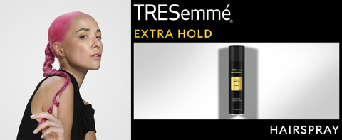 Woman with pink hair in a long braid next to Extra Hold Hairspray and black accents.