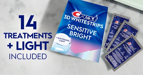 14 Treatments + Light Included. Pack of Crest 3DWhitestrips Sensitive Bright + Light next to 3 sachets on a marble counter.