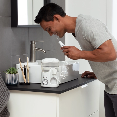 Male Using the White Ultra Water Flosser WP-100