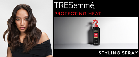 Woman with wavy, healthy dark hair next to Protecting Heat Styling Spray bottle and black accents.