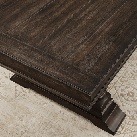 Top-down view of a corner of the table to show the textured finish, with views of the crown and base mouldings.