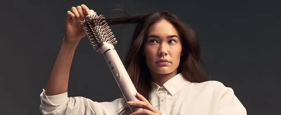 Woman holding the Airbrush 360 with Oval Brush Attachment