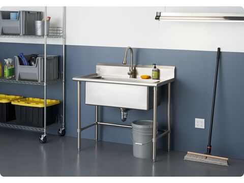 large stainless steel utility sink in a home garage