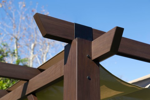 Close up of the frame of the Modena Pergola. Can see the wood grain finish on the aluminum structure.