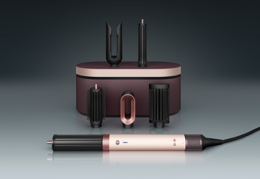 The Dyson Airwrap Co-anda2x multi-styler and dryer in front of a presentation case with a range of accessories.
