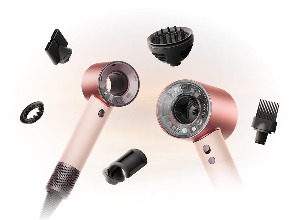 Dyson Supersonic Nural and Travel hair dryers surrounded by attachments.