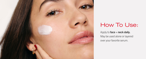 Young woman demonstrating use of firming day cream with cheek application