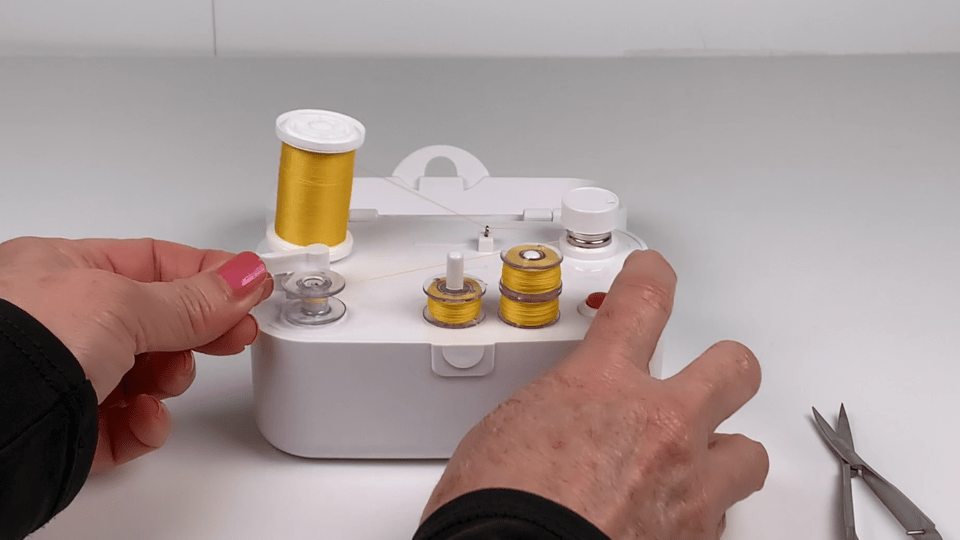thumbnail video image 2 of SINGER® Universal Bobbin Winder for Sewing Machines - For Class 15 and 15J Bobbins - Battery Powered With Included Power Adapter, White, 2 of 10