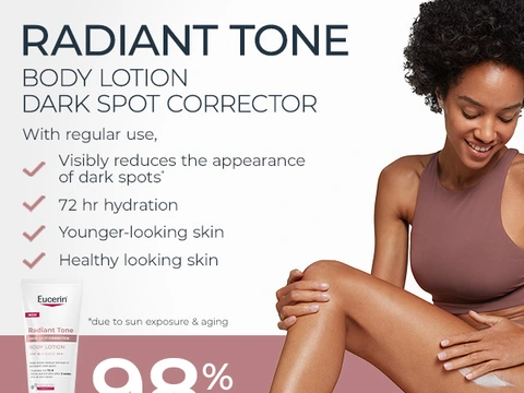 Radiant Tone Body Lotion Dark Spot Corrector with woman smiling; visibly reduces appearance of dark spots with regular use; tan sleeveless top on light background.