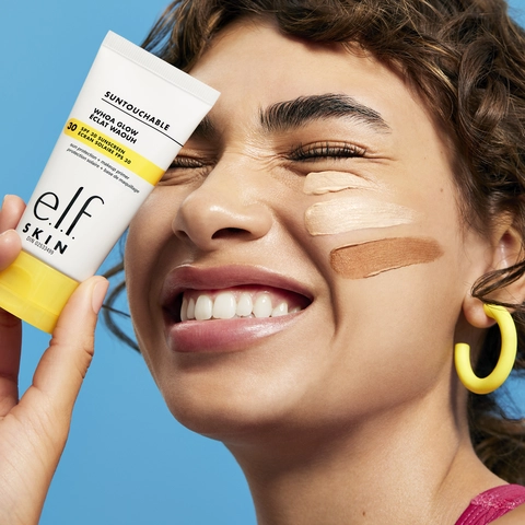 Lifestyle image of a model holding the e.l.f. Whoa Glow SPF 30