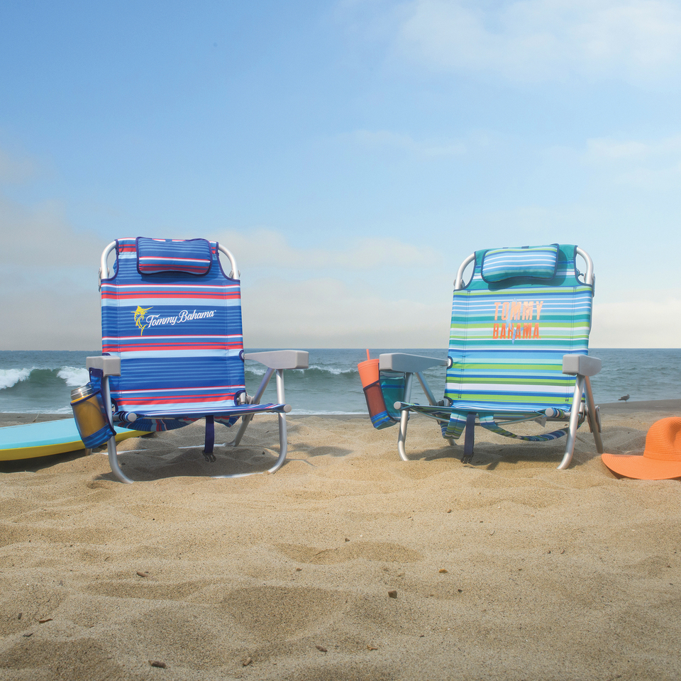 Two beach chairs on the beach.