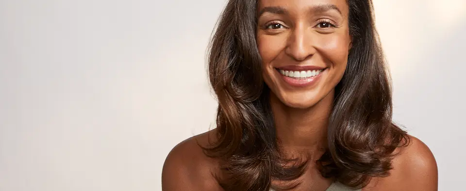 Smiling woman with blown out hair using the AireBrush