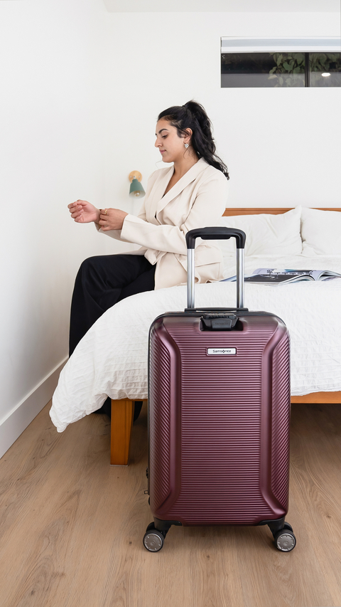 Luggage in front of bed.