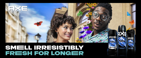 AXE body sprays upfront with a man &amp; woman in city with colorful butterflies &amp; flowers behind them.