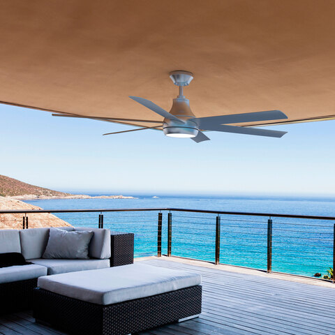 The smart ceiling fan mounted on a balcony ceiling overlooking a body of water