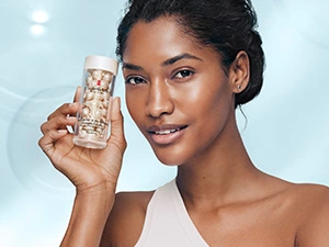 Why a capsule? Model holding Elizabeth Arden Hyaluronic Acid + Peptides Ceramide Capsules