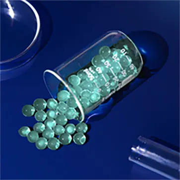 A top-view image of a beaker spilling green caviar pellets over a blue surface.