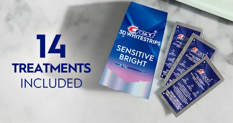 14 Treatments Included. Pack of Crest 3DWhitestrips Sensitive Bright next to 3 sachets on a marble counter.