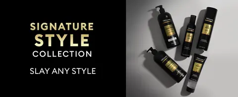 Black background with TRESemmé black bottles featuring gold labels placed on a light gray surface.