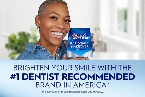 Woman smiling holding Crest 3DWhitestrips Rapid Smile Makeover pack. Brighten Your Smile with the #1 Dentist Recommended Brand in America.