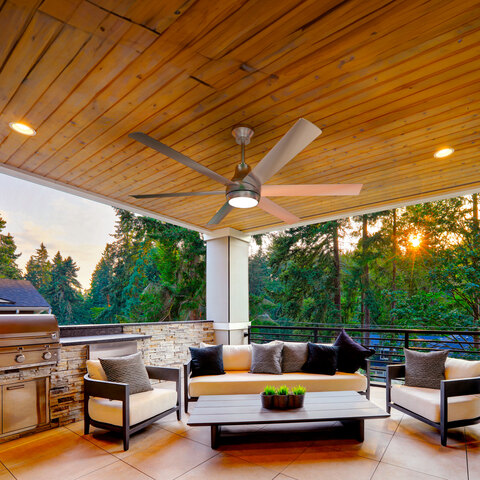 The Atomi Smart Outdoor Fan being used on a covered patio