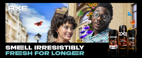 AXE body sprays upfront with a man &amp; woman in city with colorful butterflies &amp; flowers behind them.