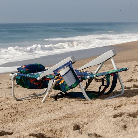 Beach chair fully reclined on beach.