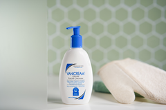 A bottle of Vanicream Gentle Facial Cleanser sits on a bathroom counter. This is the 8 oz pump-top size.