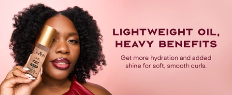 Woman with healthy-looking hair holding the SheaMoisture Smooth &amp; Shine Lightweight Hair Oil.