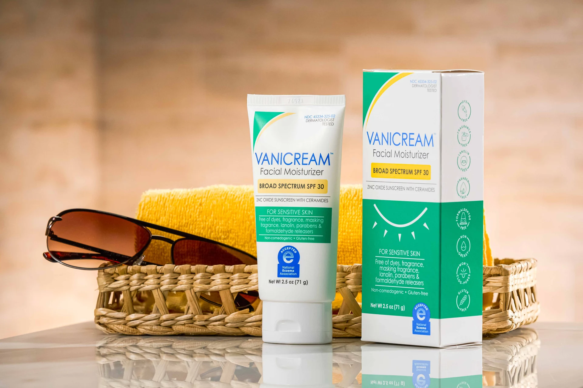 A tube and carton of Vanicream™ Facial Moisturizer SPF 30 rest on a bathroom counter.