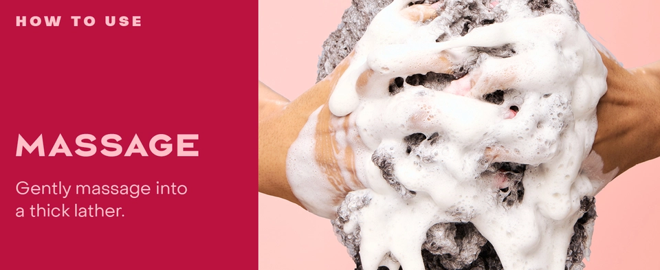 Close up shot of woman&#39;s hands massaging heir covered in foam, next to massaging instructions.
