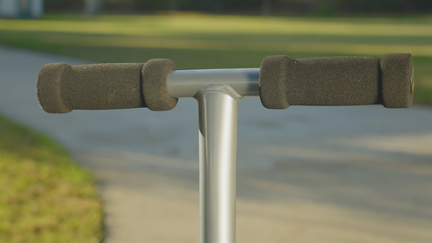 A close up picture of the foamed handlebar of a scooter