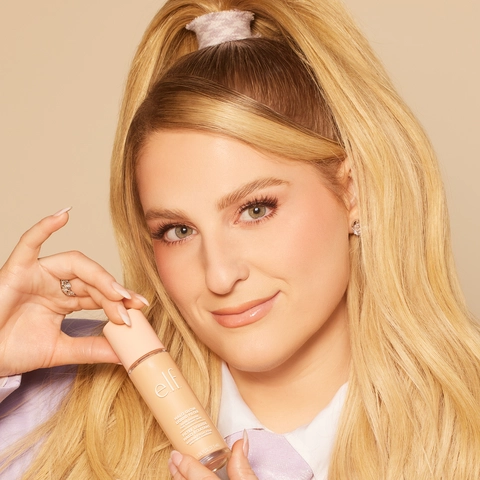 Meghan Trainor holding Halo Glow Liquid Filter in hands