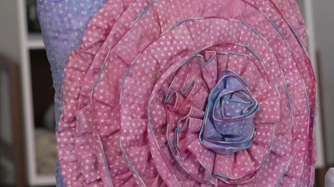A tri-color square pillow was created using the gathering foot; the base is purple-white polka dots. It has pink-white polka dots flower applique &amp; purple-white polka dots pistil. The flower applique was sewn using the gathering foot.