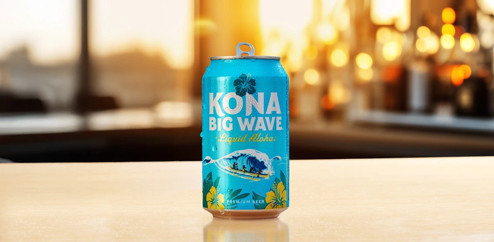 Can of Kona Big Wave Premium Beer on a bar at sunset.