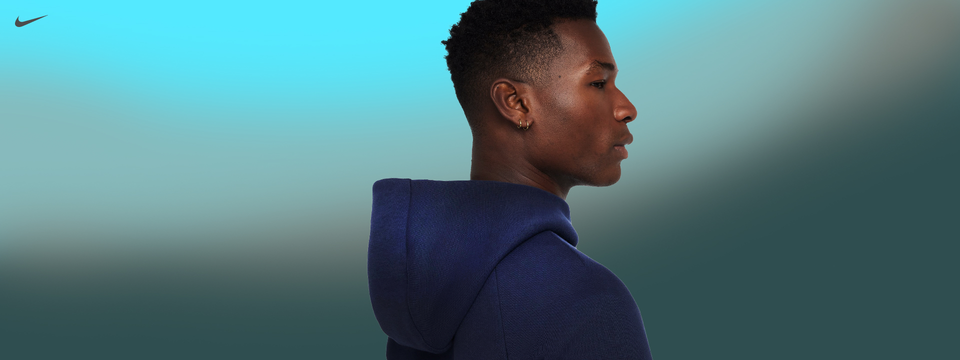 Profile view of man in Nike hoodie, with focus on hood and athletic fit.