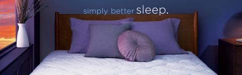 Front profile of Novaform Comfort Grande Mattress at sunset with banner saying simply better sleep