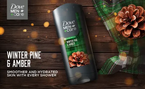 Image of Dove Men+Care Winter Pine &amp; Amber BODY WASH against wooden background.