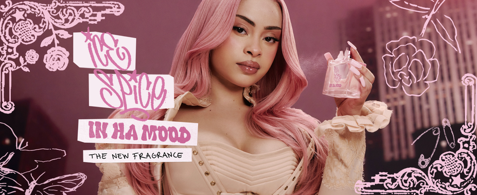 Ice Spice holding a perfume bottle