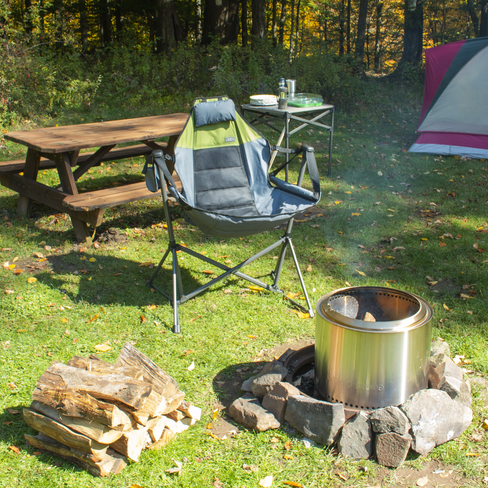 Swing chair on camp ground next to fire pit