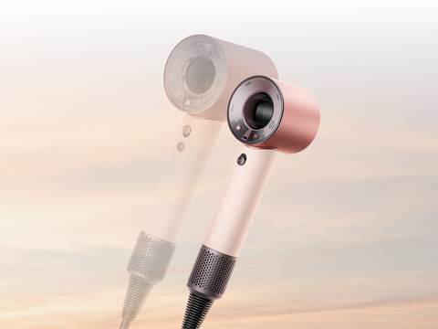 The Dyson Supersonic Travel hair dryer in front of the Dyson Supersonic Nural hair dryer.