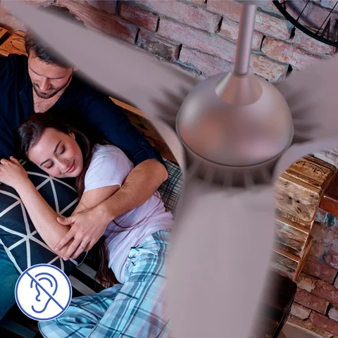 A couple sleeping on the couch as the smart fan cools the room