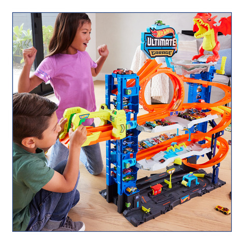 Setting up a house with a garage with colored pieces to play with and  playing with hot wheels 