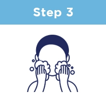 Step Three: A person massaging their face with foamy suds