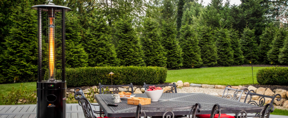 Paragon Outdoor Illume Propane Patio Heater on backyard deck next to dining table.