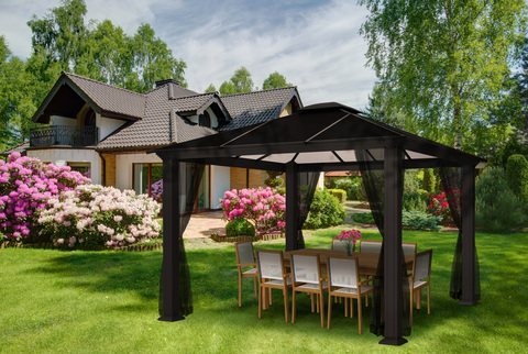 Santa Monica Gazebo with Mosquito Netting in backyard with dining table underneath.