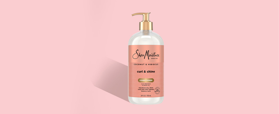 Image of the SheaMoisture Curl &amp; Shine Conditioner pump bottle, next to applying instructions.