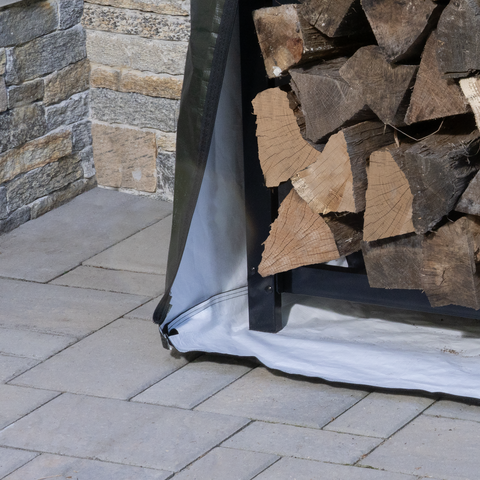 Bottom of full firewood rack sitting on top of fabric cover.