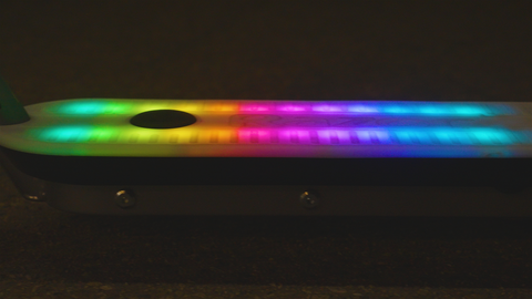 A close up image of the multi-colored light-up deck of a scooter