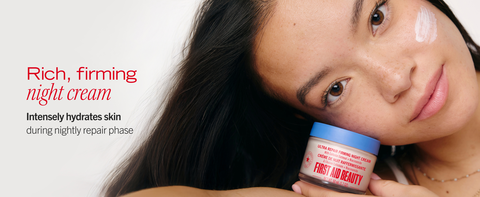 Woman holding firming night cream against her cheek
